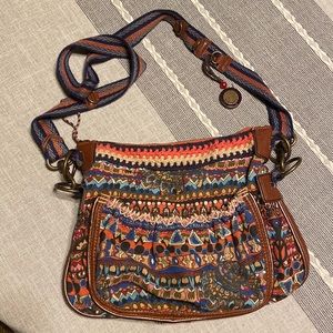 Sakroots purse. Woven strap and leather trimmed.